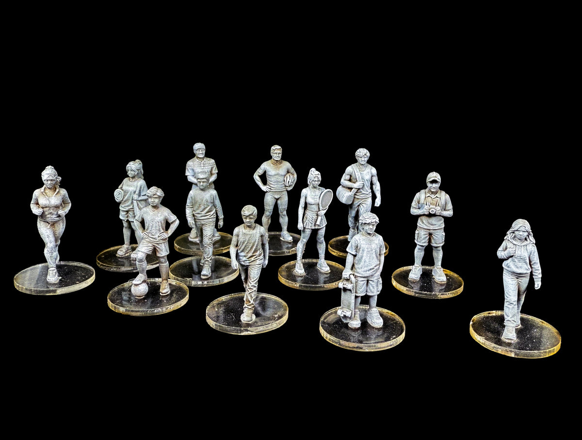 Front view of 12 unpainted 28mm Western civilian miniatures featuring athletes and children